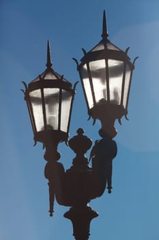 two old lanterns against the blue sky