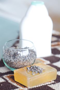 cosmetic container ,lavender and soap on ethnic mat