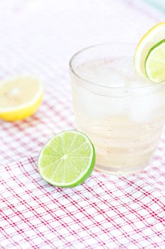 water with lemon and lime in a glass with ice