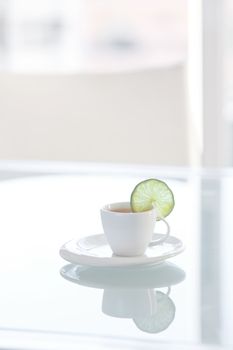 cup of tea with lemon on a glass surface