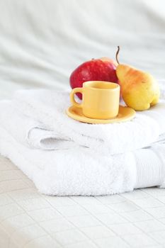 cup of tea,apple and pear on the bed