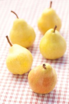 pears lying on a plaid fabric