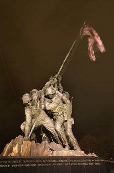 The Marine Corps War Memorial Shows the Raising of the Flag at Iwo Jima in World War II  Washington DC Public Monument  Plane Trail in Background