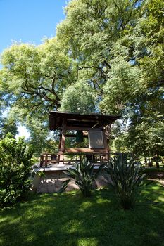 Japanese bell in the background of green trees