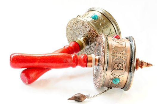 Tibetan prayer wheels on a white background
