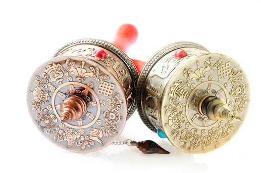 Tibetan prayer wheels on a white background