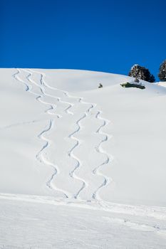 Traces of the snowboard on the mountain. The Alpine skiing resort in Austria Zillertal.