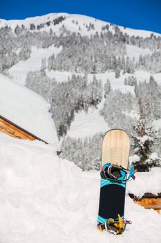Snowboard stuck in the snow. The Alpine skiing resort in Austria Zillertal
