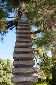 stone pagoda on the background of green trees