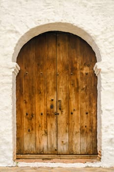 Wooden door on the side of a white colonial church