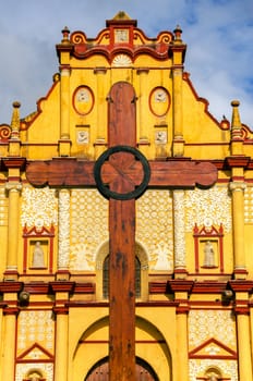 View of the facade of the cathedral and wooden cross in San Cristobal de las Casas in Chiapas, Mexico