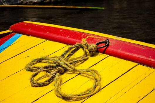 Closeup of a colorful boat and rope in Xochimilco canals in Mexico City