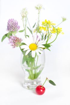 bouquet of wild flowers and cherry with green leaf