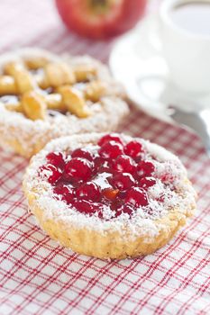 apple,beautiful cake with berries and tea on plaid fabric