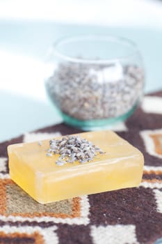 lavender in bowl and soap on ethnic mat