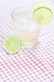 water with lemon and lime in a glass with ice