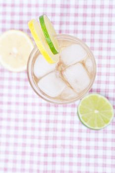 water with lemon and lime in a glass with ice