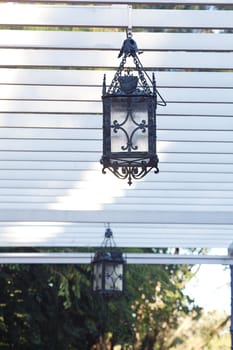 decorative lantern hanging in the arbor