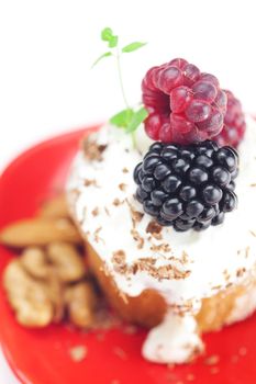 muffin with whipped cream,mint, raspberries, blackberries and nuts