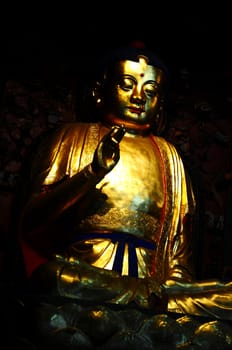 Golden Buddha statue in a traditional Chinese ancient temple