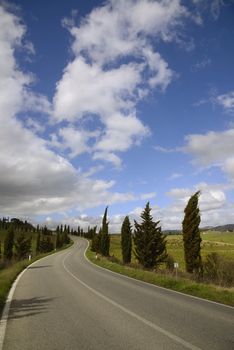 A curve road under a cloudy sky