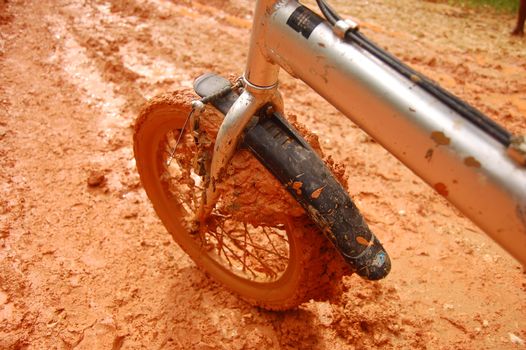 Brown muddy bycicle front wheel, Papua New Guinea