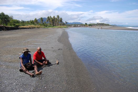 Men sit at river coast on May 10th 2011.
Papua New Guinea