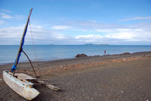 Sailing canoe at ocean beach, Papua New Guinea