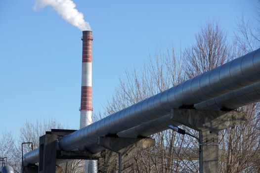 Industrial pipes on a background of the blue sky