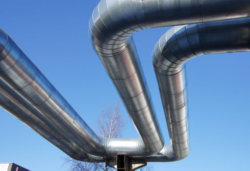 Bend of industrial pipes on a background of the sky