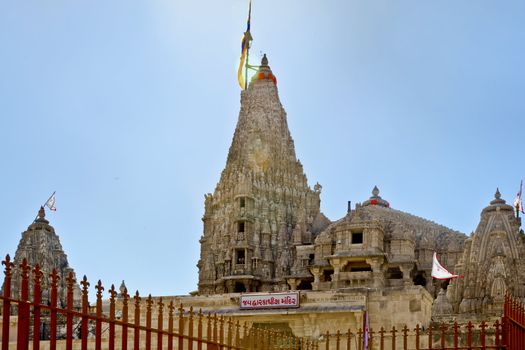 Dwarka Roadtrip. Landscape capture of the  Shree Dwarakadheesh Temple from one of the side alleys in Guajarat India. The sign reads ' Jai Dwarakadheesh Mandir' in Gujarati. Mandir means temple. This photograph has lens flare.