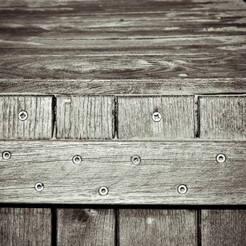 Dramatic monochrome close up of the edge of a wooden storage trunk