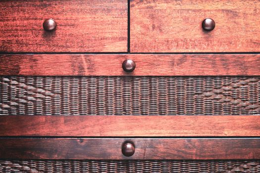 Close up of a chest of drawers made from mahogany wood