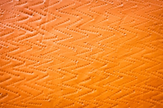 A textured background image of a bright orange wall