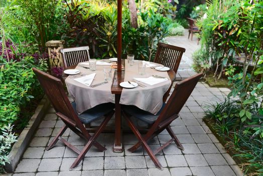 Summer outdoor cafe in a green garden