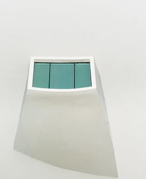 Modern window with green glass on white wall