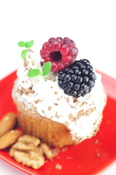 muffin with whipped cream,mint, raspberries, blackberries and nuts