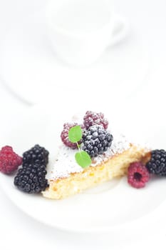 cup, cake, raspberry, blackberry,nuts and mint on a plate on a white background