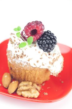 muffin with whipped cream,mint, raspberries, blackberries and nuts