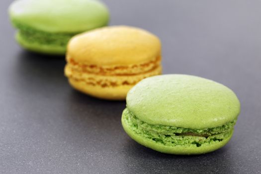 three green and yellow macaroons in kitchen