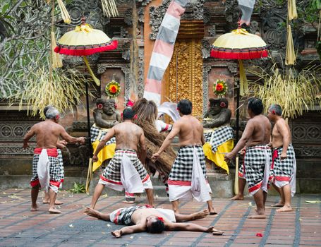 UBUD, BALI, INDONESIA - SEP 21: Kris-wielding dancers fight with Rangla on traditional balinese Barong dance performance on Sep 21, 2012 in Ubud, Bali, Indonesia. It is popular tourist attraction show