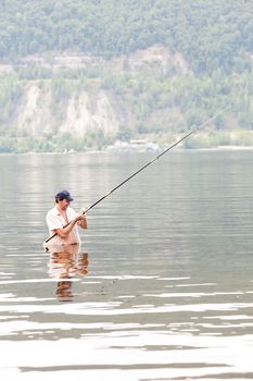 young man fishing in the river