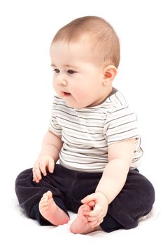 Thoughtful child sits and looks aside. Isolated.