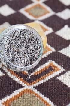 lavender in bowl and soap on ethnic mat