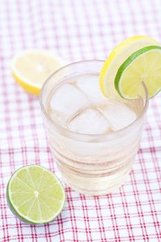 water with lemon and lime in a glass with ice