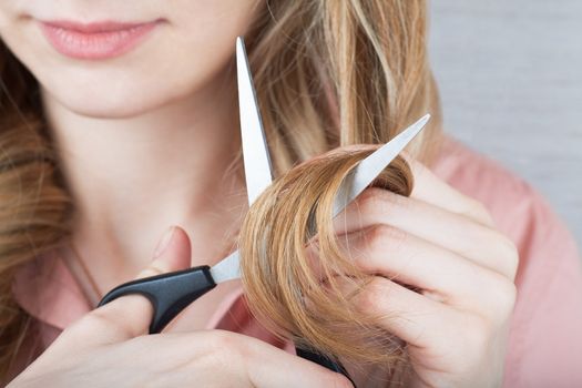 Closeup view of woman cutting her hair
