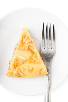 Closeup view of piece of sweet pie and fork on a white plate