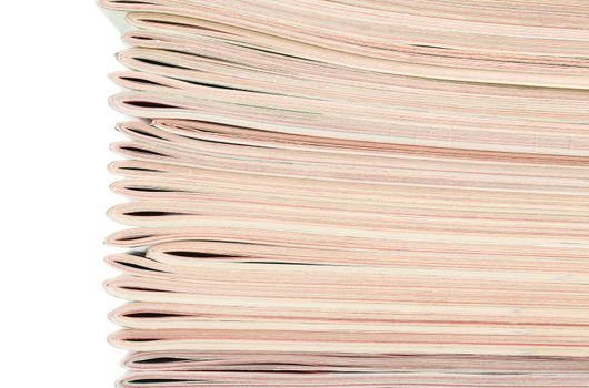 Closeup view of stack of magazines isolated over white background