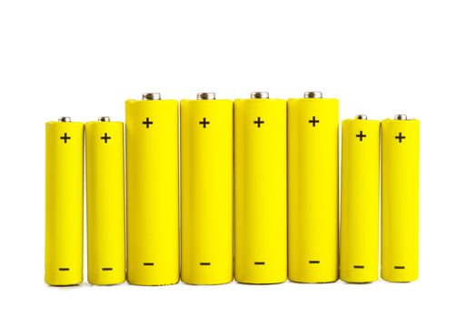 A row of yellow batteries isolated over white background