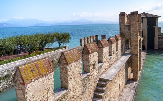 Garda lake stony wall fortificatino in Sirmione harbor